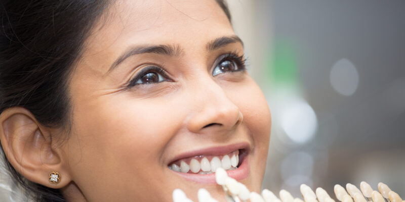 Patient undergoing the porcelain dental veneer color matching process in Montgomery, OH.