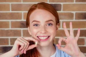 Girl from Blue Ash shows off her tooth after receiving an extraction
